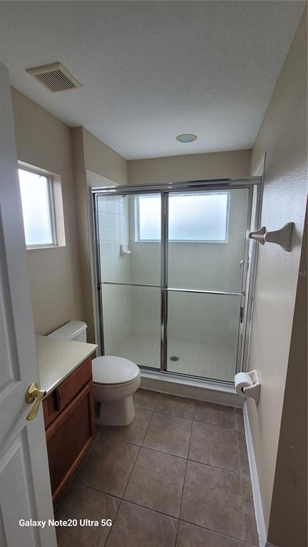 1040 Marcello Boulevard Kissimmee, FL 34746 - Photo 13 of 24 a bathroom with a shower and a toilet