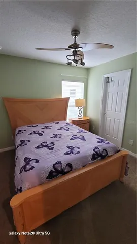 a bed sitting in a bedroom next to a larger window