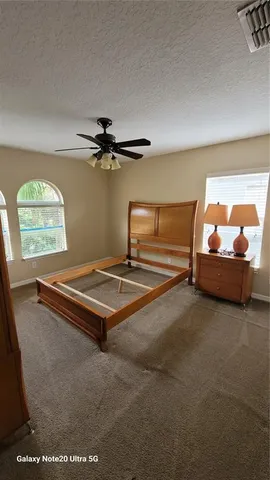 a living room with a bed furniture and a window