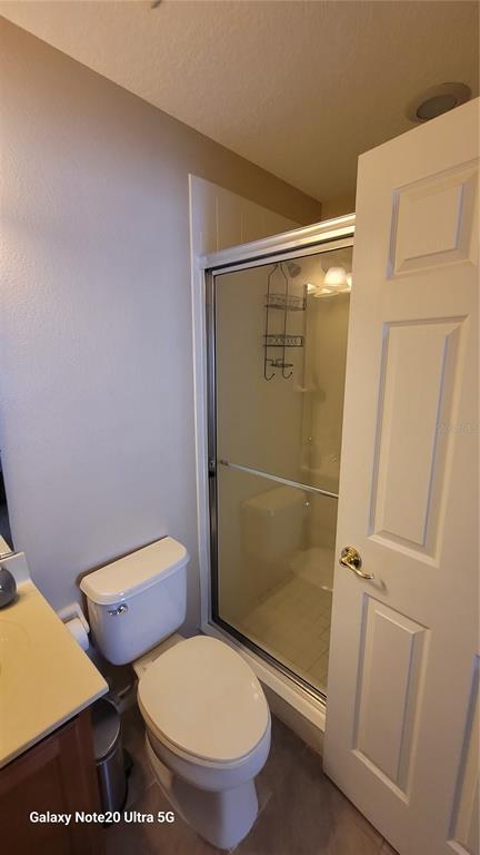 1040 Marcello Boulevard Kissimmee, FL 34746 - Photo 19 of 24 a bathroom with a toilet and a shower