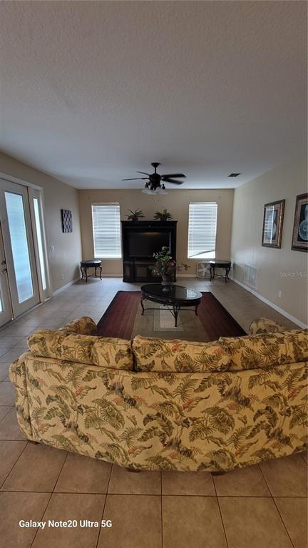 1040 Marcello Boulevard Kissimmee, FL 34746 - Photo 3 of 24 a living room with a couch and fireplace