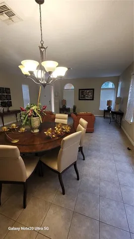 a living room with furniture a table and chairs