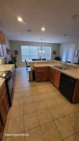 a kitchen with stainless steel appliances granite countertop a sink and cabinets