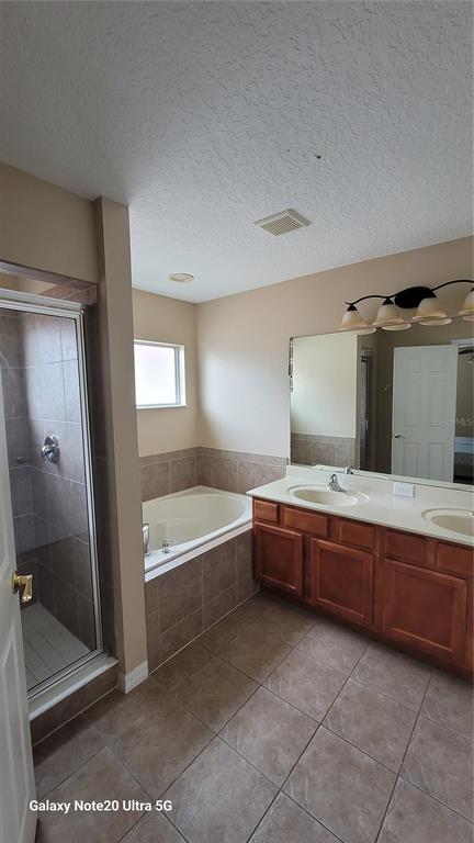 1040 Marcello Boulevard Kissimmee, FL 34746 - Photo 10 of 24 a large bathroom with a large tub and shower