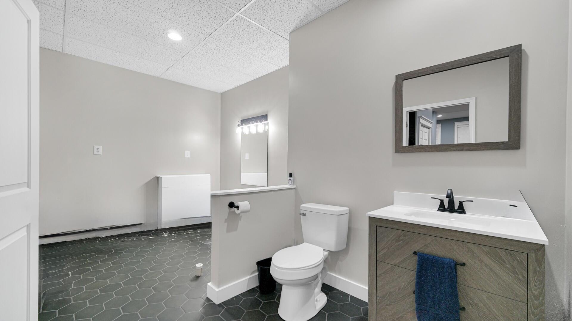 10300 Illinois Street Crown Point, IN 46307 - Photo 24 of 29 a bathroom with a toilet sink and mirror
