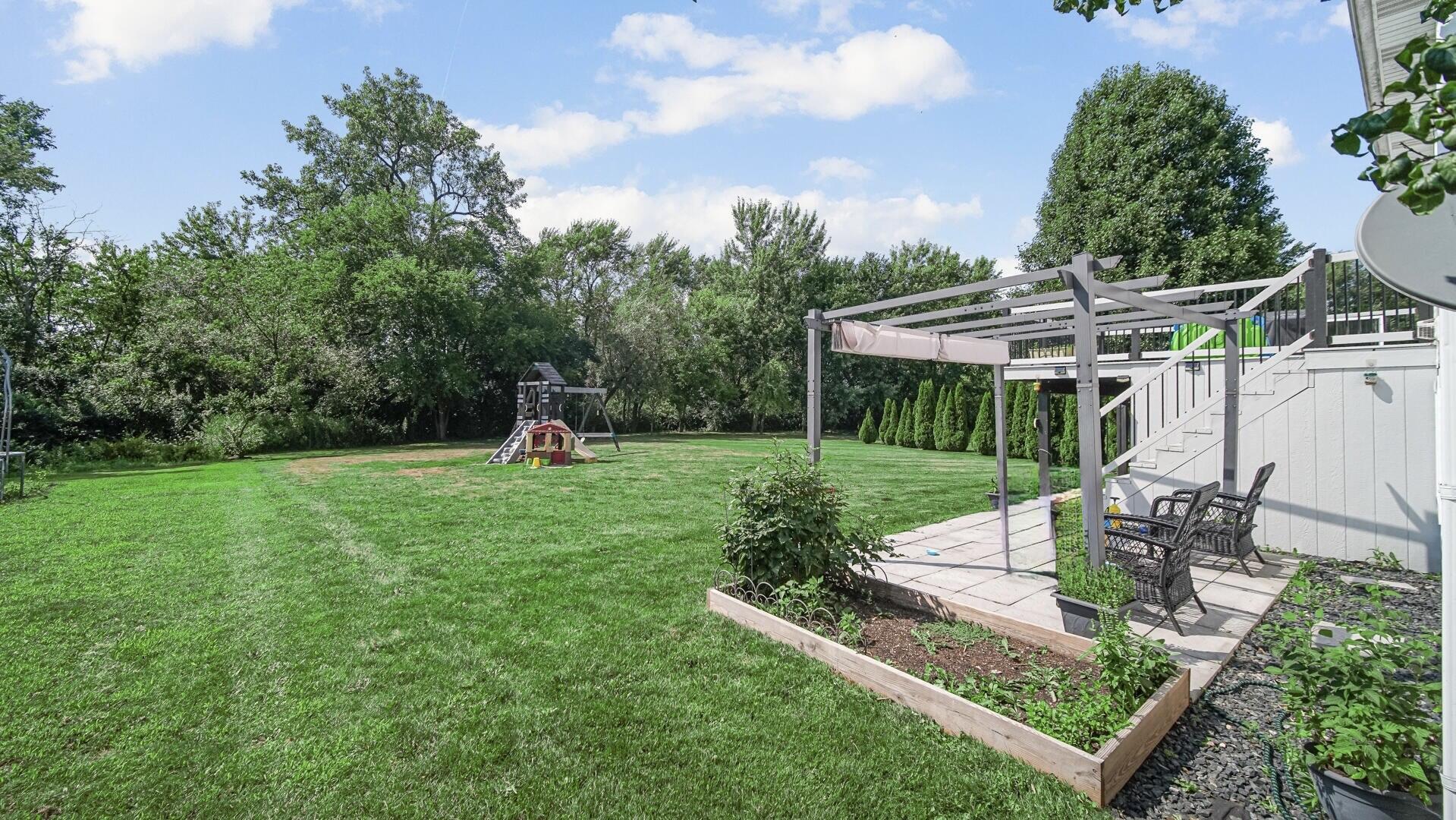 10300 Illinois Street Crown Point, IN 46307 - Photo 25 of 29 a front view of a house with a yard table and chairs