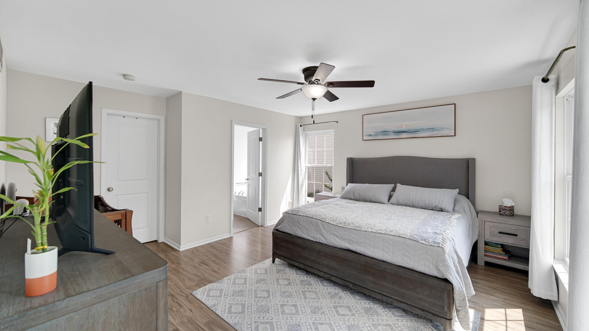 10300 Illinois Street Crown Point, IN 46307 - Photo 10 of 29 a bedroom with a bed table and a potted plant
