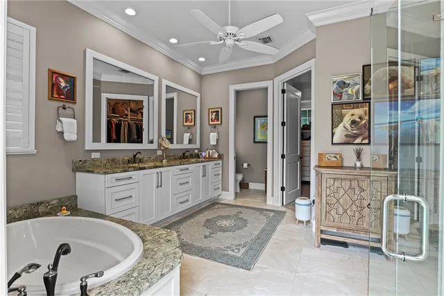 a bathroom with a granite countertop tub sink and mirror