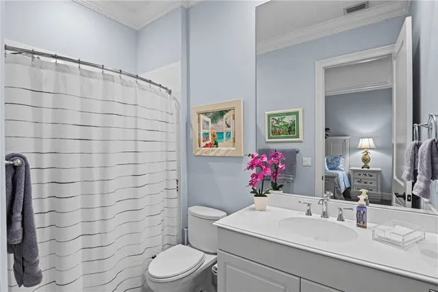 a bathroom with a sink mirror vanity and toilet