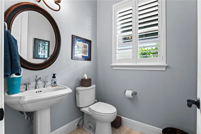 a bathroom with a toilet a sink and a mirror