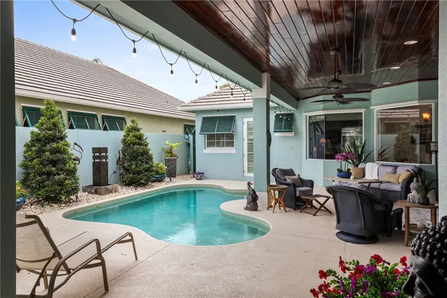 a swimming pool with outdoor seating and yard