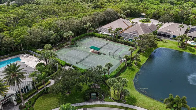 an aerial view of a house with yard and swimming pool
