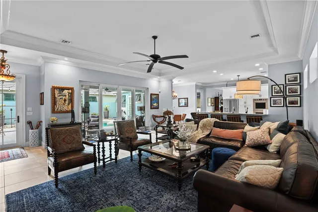 a living room with furniture ceiling fan and a rug