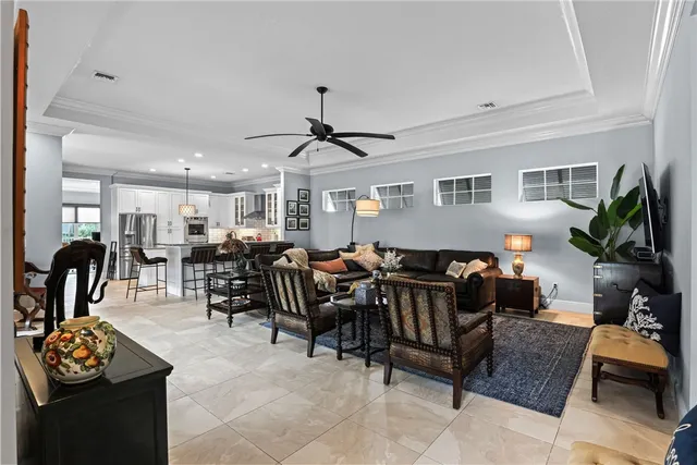 a living room with furniture potted plant and a window