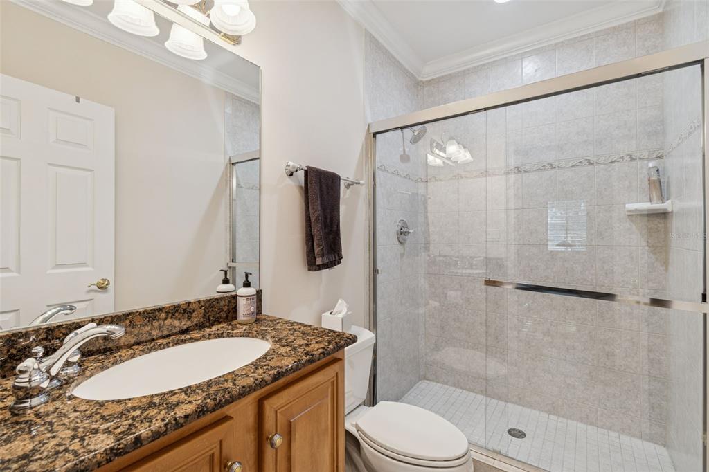1001 South Rome Avenue, Unit 9 Tampa, FL 33606 - Photo 14 of 25 a bathroom with a granite countertop sink toilet and shower