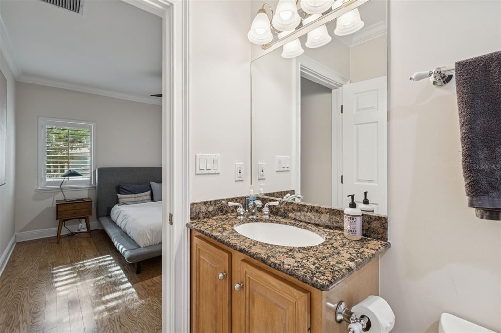 1001 South Rome Avenue, Unit 9 Tampa, FL 33606 - Photo 20 of 25 a en suite bathroom with a granite countertop sink and a mirror