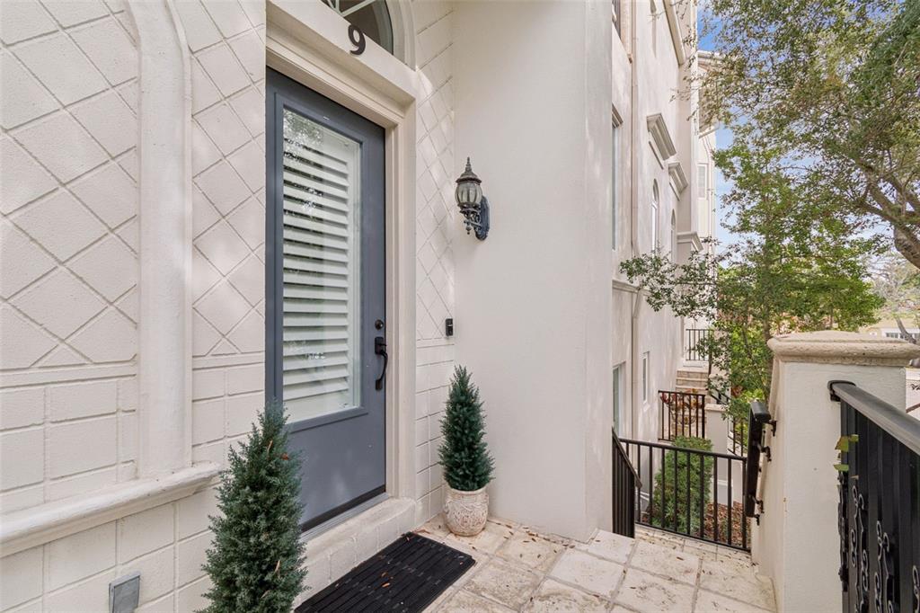 1001 South Rome Avenue, Unit 9 Tampa, FL 33606 - Photo 3 of 25 a vase with flowers sitting on a floor in front of a door