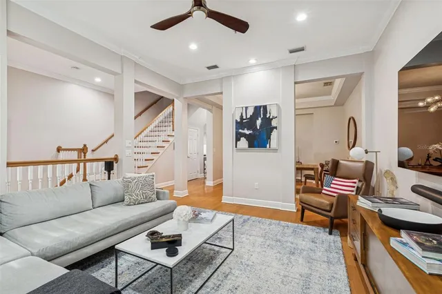 a living room with furniture and wooden floor