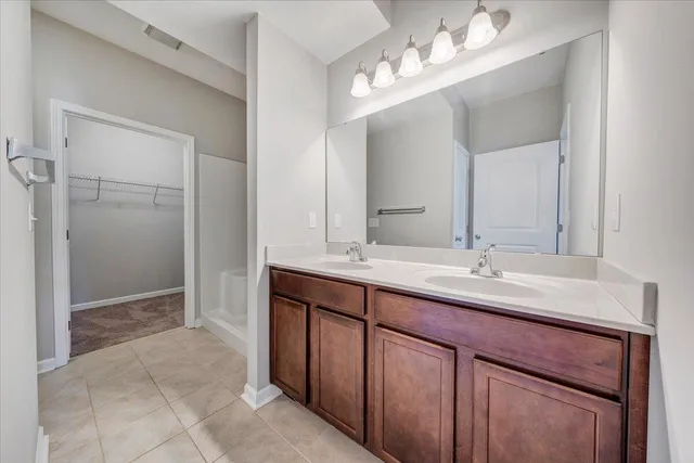 a bathroom with a double vanity sink and a mirror