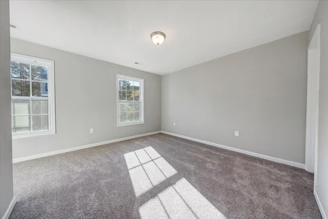 a view of an empty room with windows