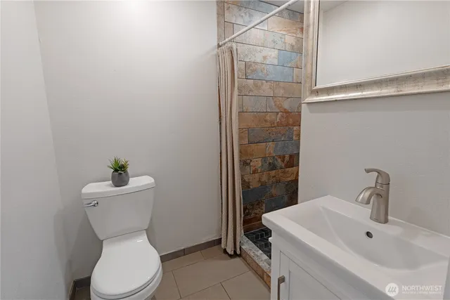 a bathroom with a sink mirror and toilet