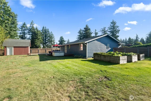 a view of a house with backyard and a tree