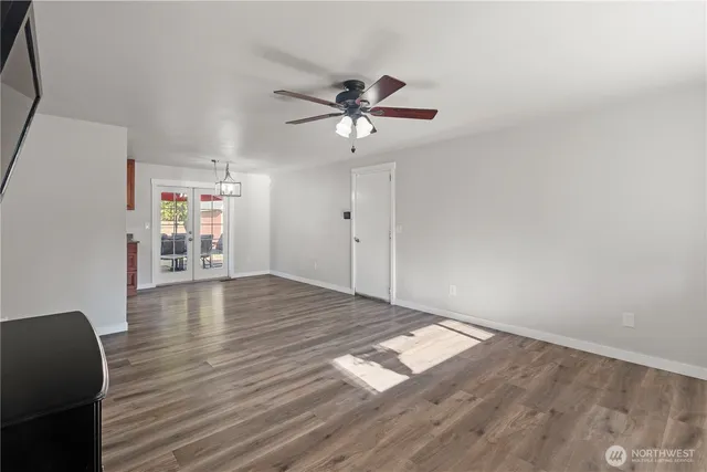 a view of empty room with wooden floor