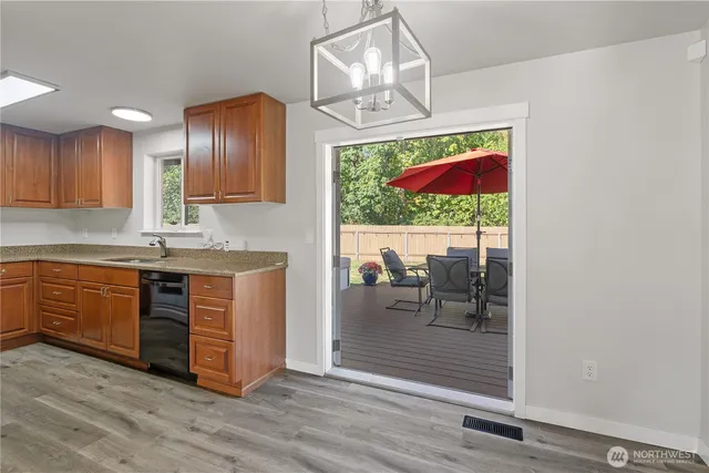a kitchen with stainless steel appliances granite countertop a stove and a wooden floors