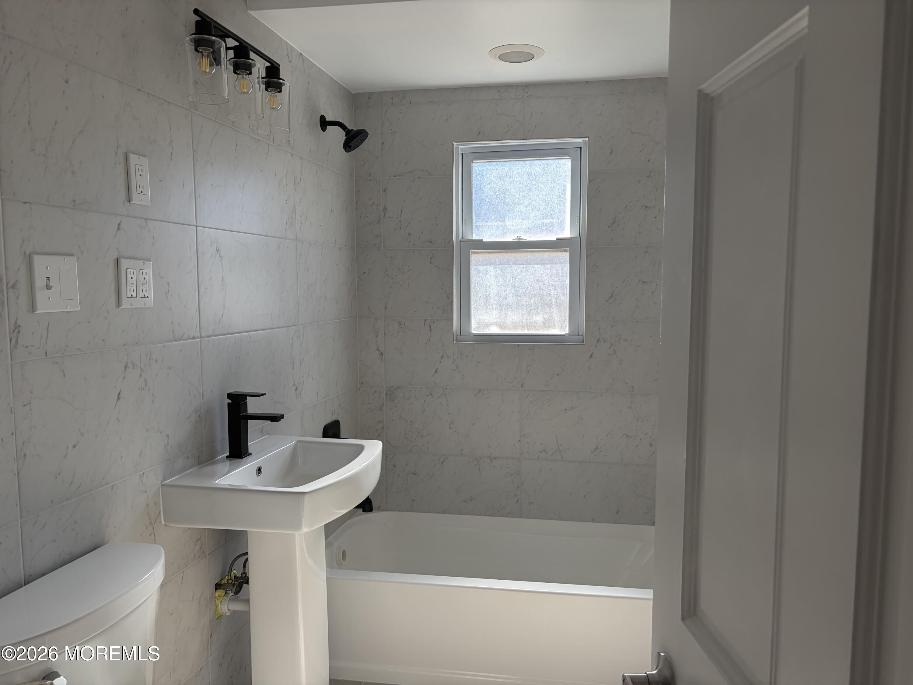 633 Hulses Corner Road Howell, NJ 07731 - Photo 4 of 11 a bathroom with a sink a mirror and a bathtub