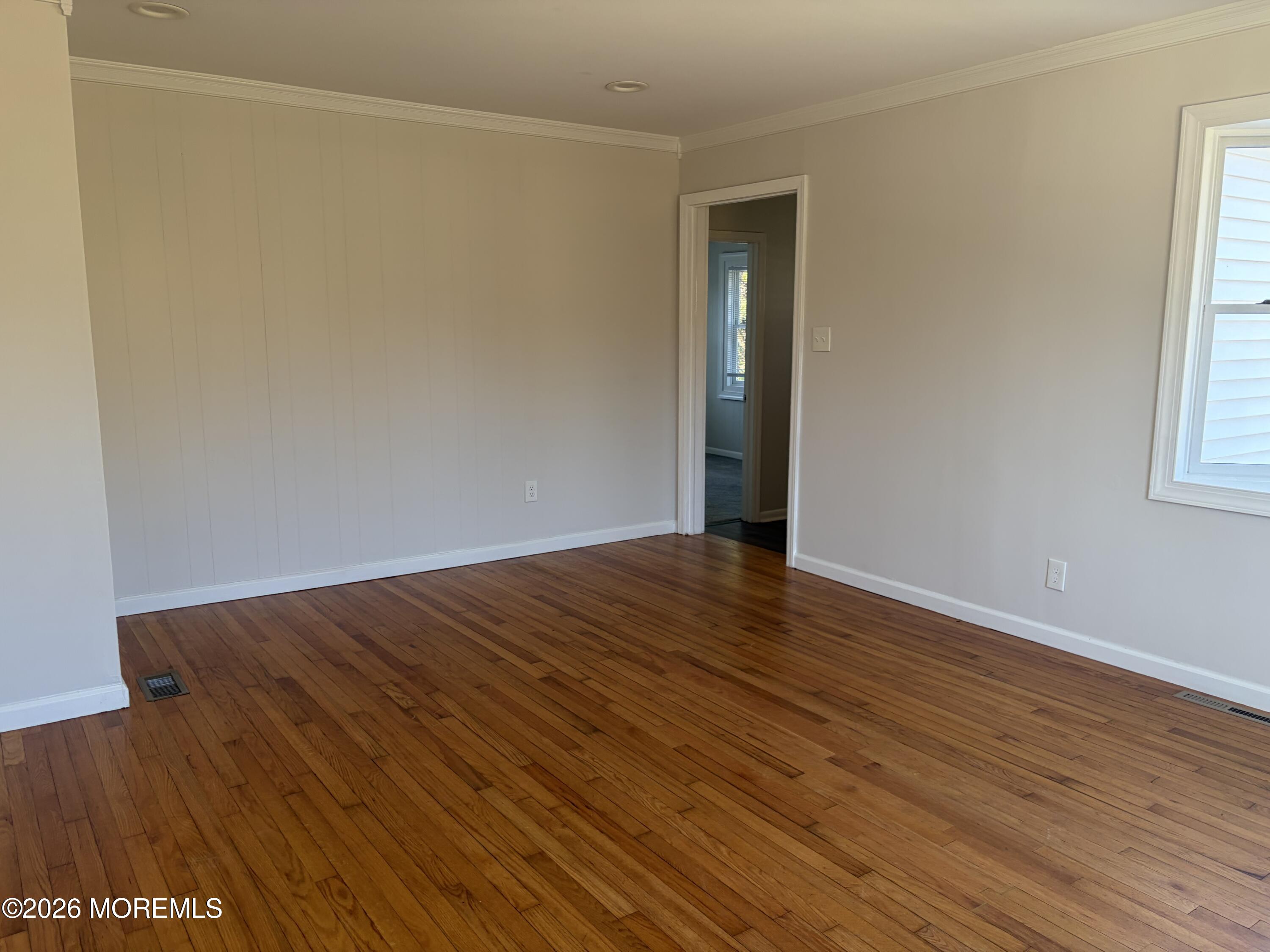 633 Hulses Corner Road Howell, NJ 07731 - Photo 5 of 11 an empty room with wooden floor and windows