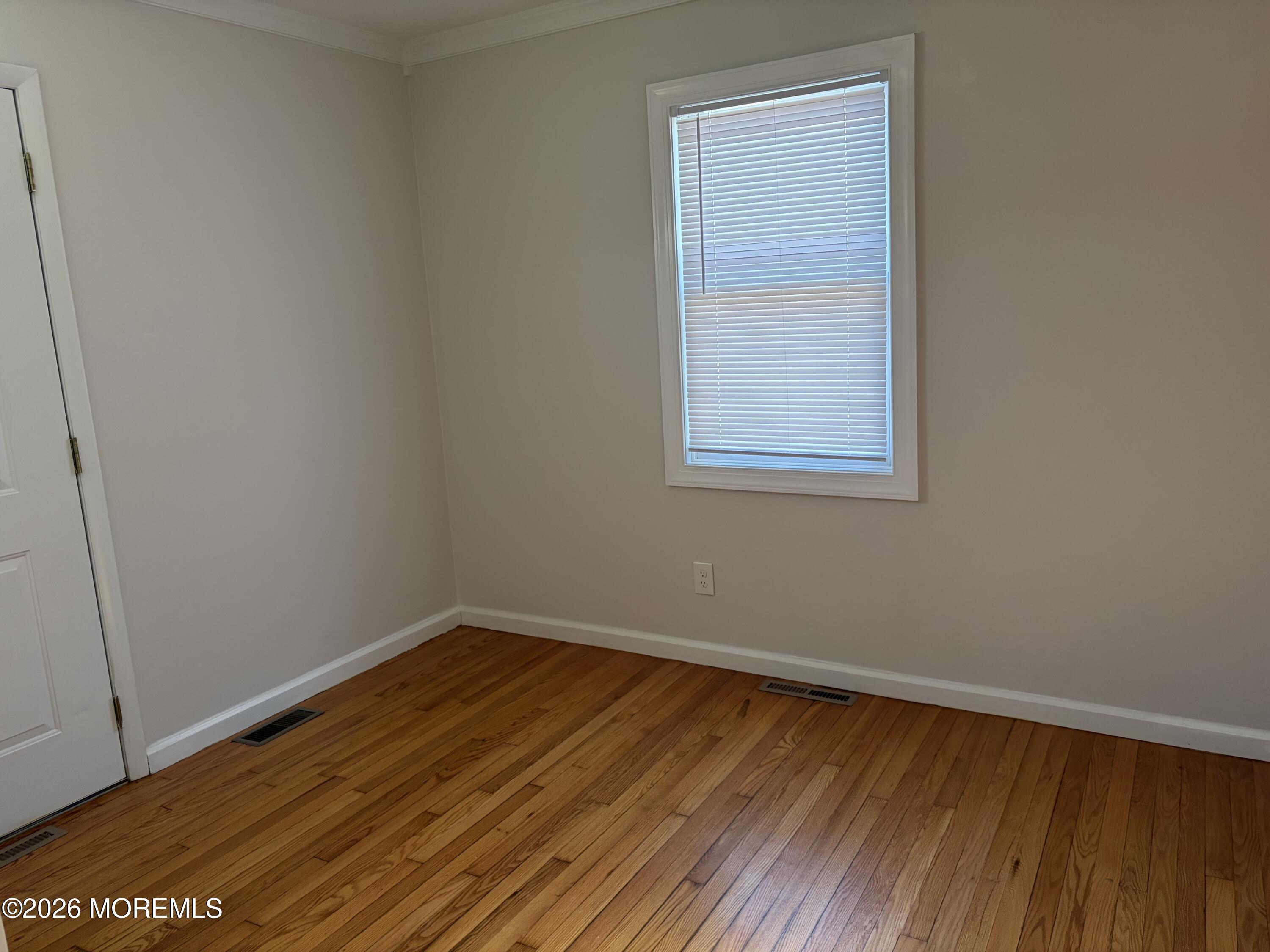 633 Hulses Corner Road Howell, NJ 07731 - Photo 8 of 11 a view of an empty room with wooden floor and a window