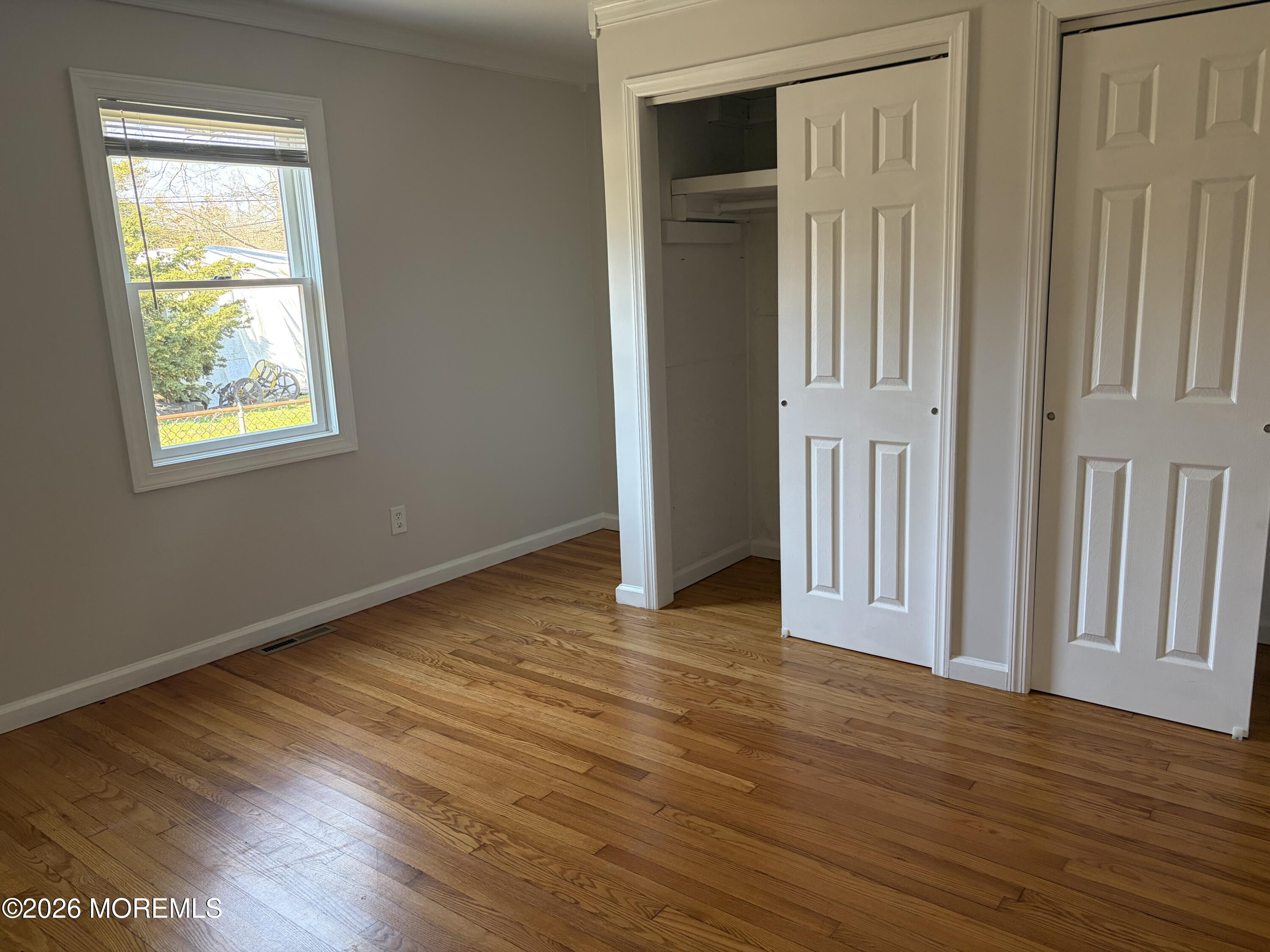 633 Hulses Corner Road Howell, NJ 07731 - Photo 9 of 11 an empty room with wooden floor and windows