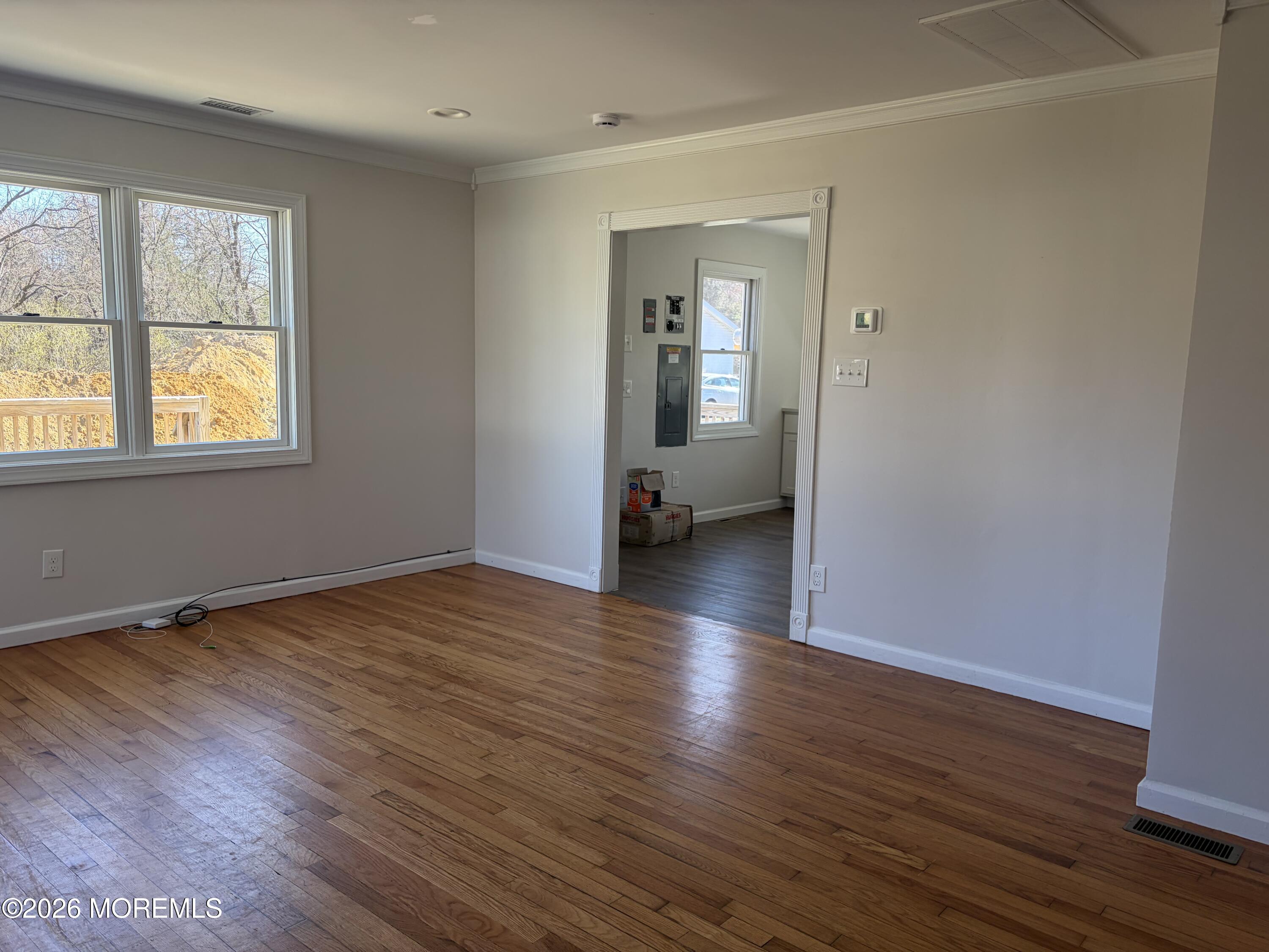 633 Hulses Corner Road Howell, NJ 07731 - Photo 10 of 11 an empty room with wooden floor and windows