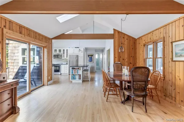a dining room with furniture and wooden floor
