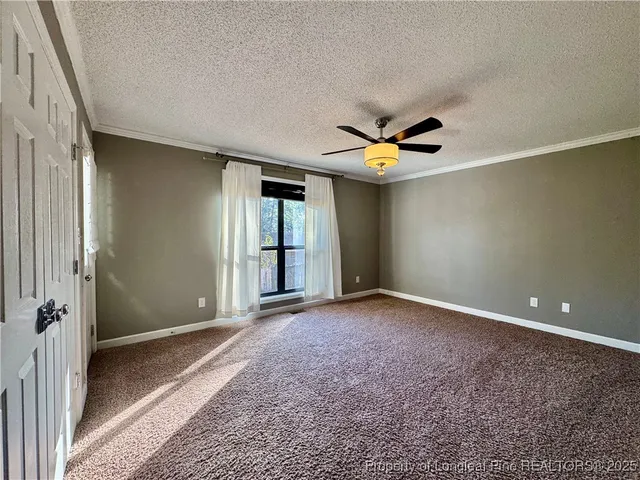 a view of a livingroom with a ceiling fan and window
