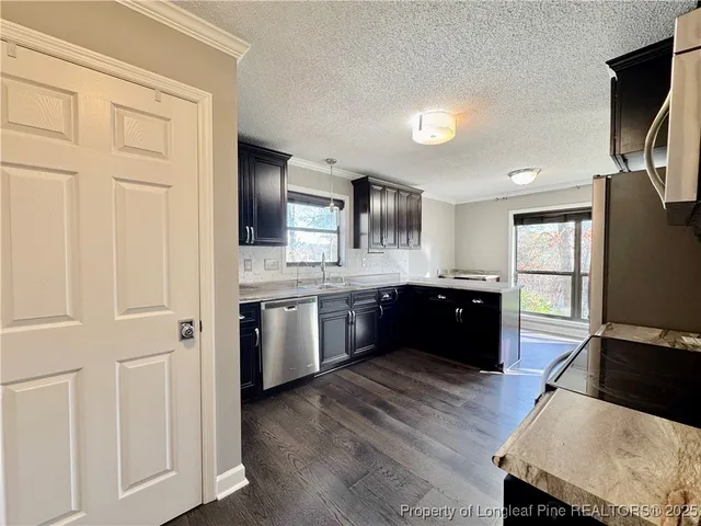 a large kitchen with a stove a sink and a refrigerator