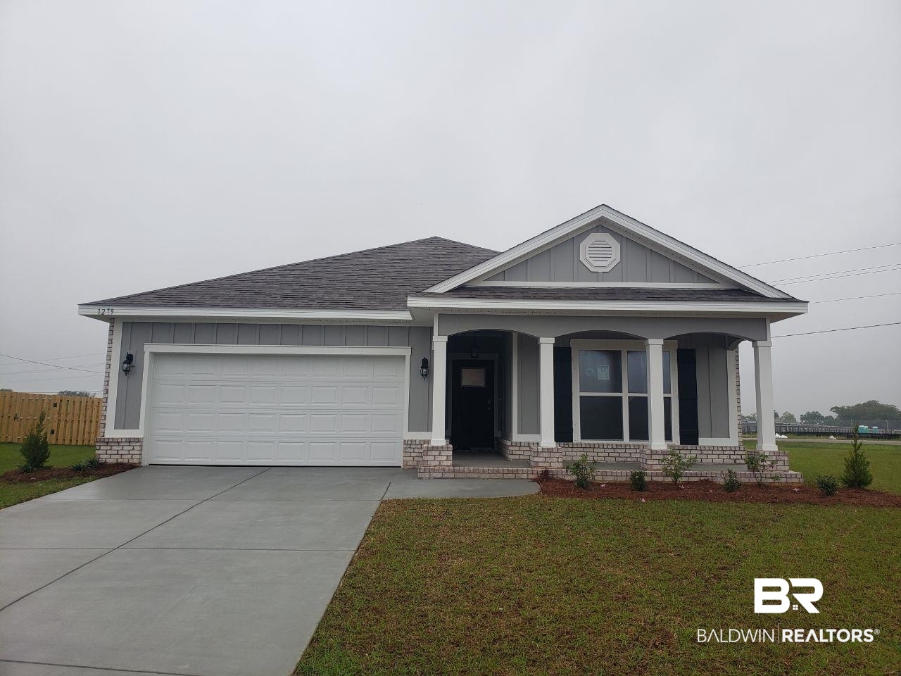 1279 Hayward Loop Foley, AL 36535 - Photo 1 of 31 View of front of property featuring an attached garage, fence, a front lawn, and concrete driveway