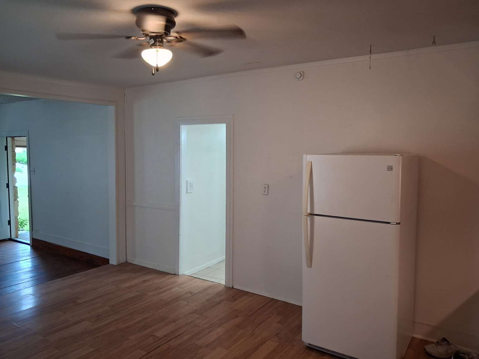 308 North Ridge Street Lampasas, TX 76550 - Photo 7 of 16 a view of a kitchen with a refrigerator and a ceiling fan