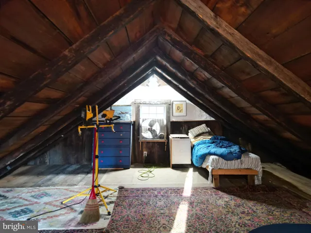 a view of dirt yard with wooden fence