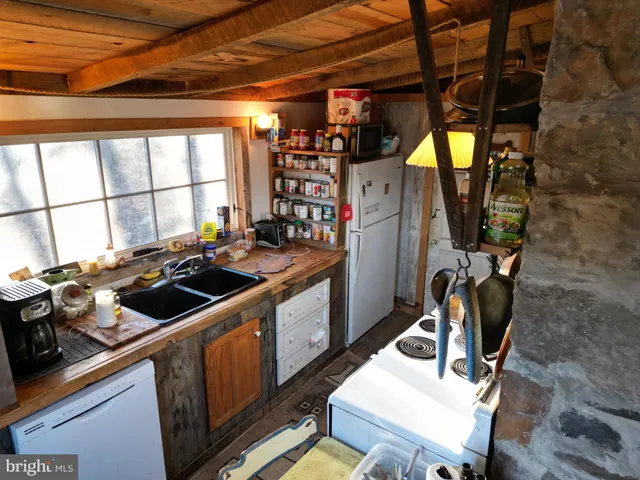 a view of a living room with furniture and large windows
