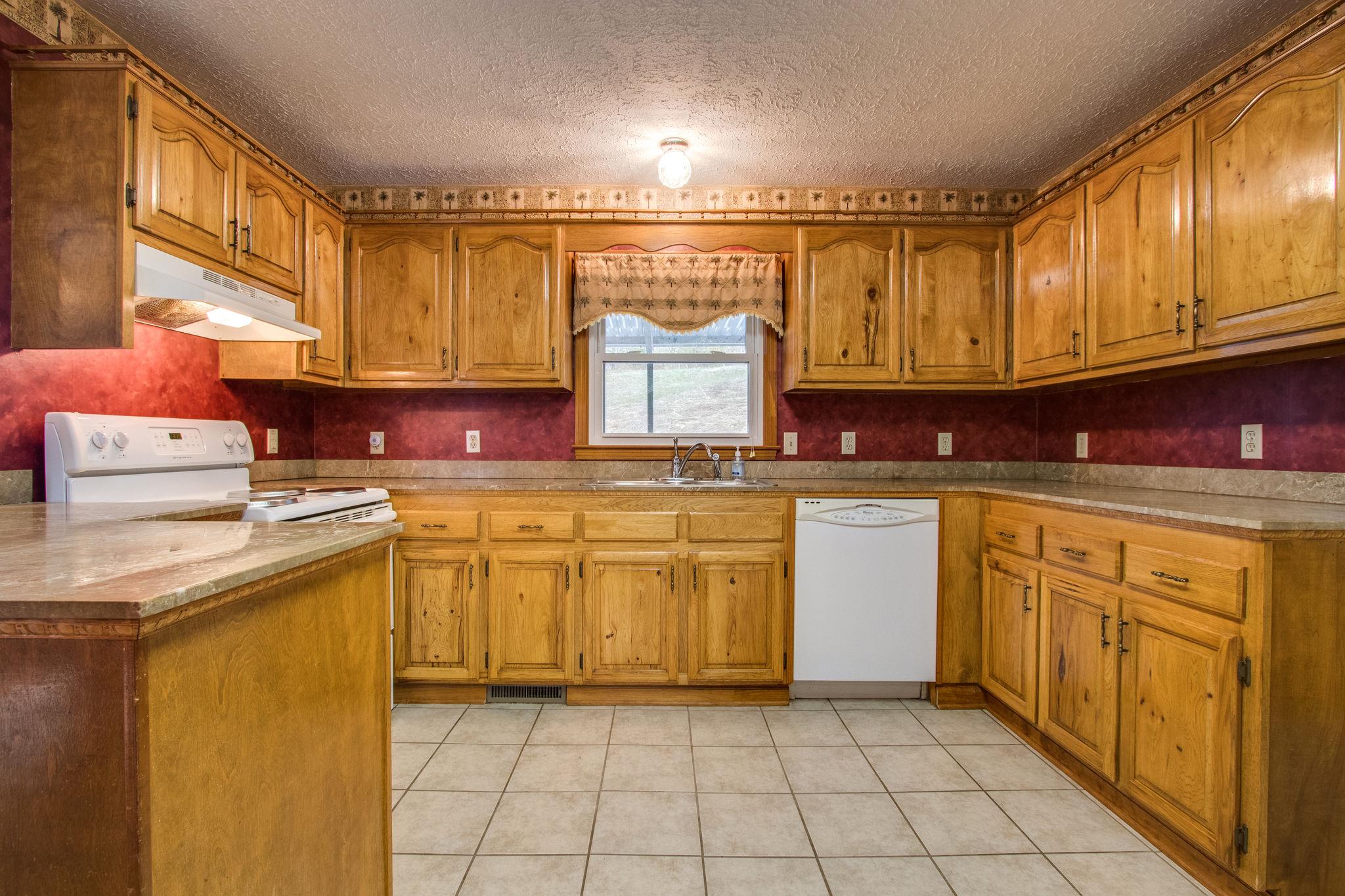 961 New Hope Road Alexandria, TN 37012 - Photo 5 of 24 Nice oak cabinets and marble countertops in kitchen! Cabinets galore!