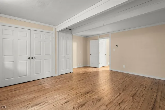 a view of an empty room and wooden floor