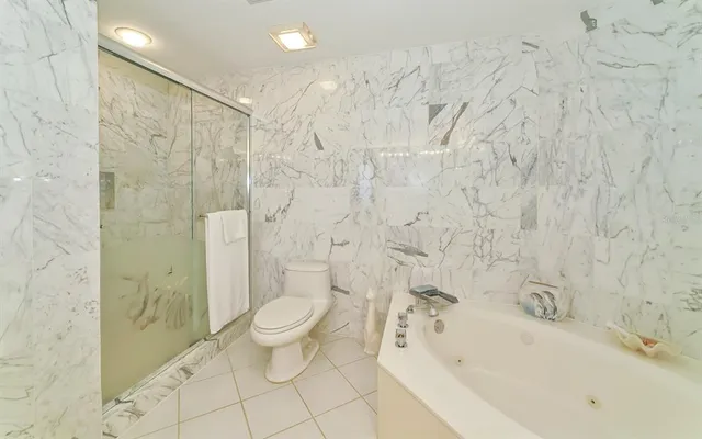a bathroom with a sink shower and a toilet