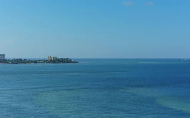 a living room with furniture a flat screen tv and a floor to ceiling window