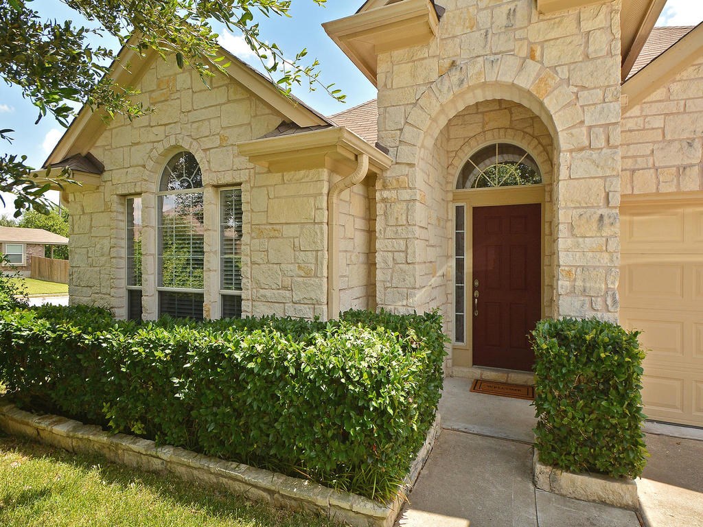 617 Windsor Castle Drive Pflugerville, TX 78660 - Photo 1 of 1 a view of a brick house with potted plants