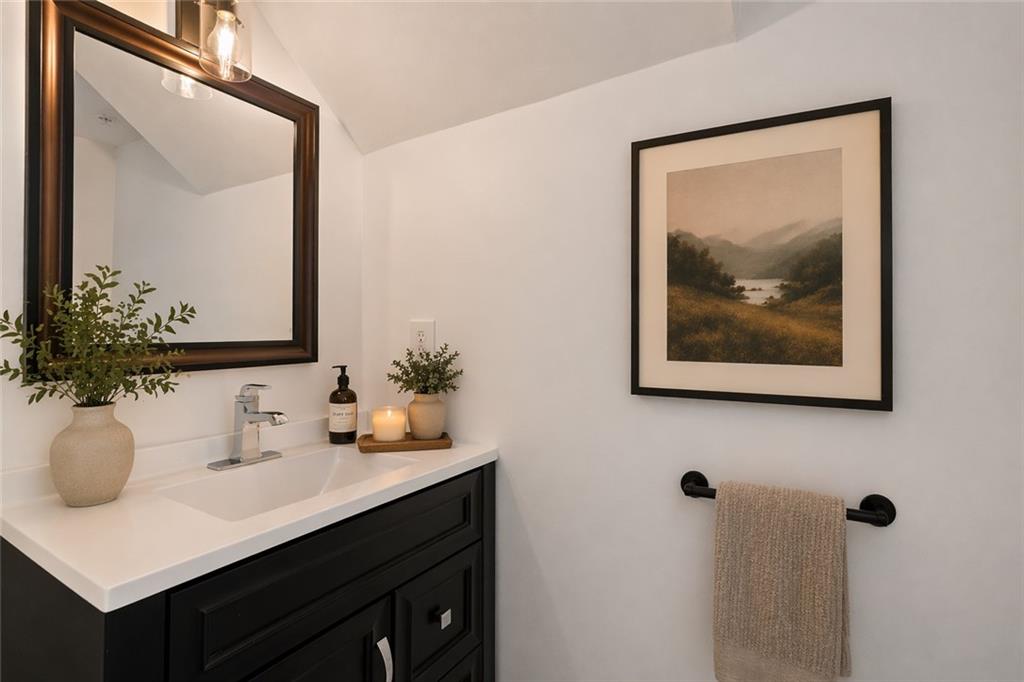 383 Ralph McGill Boulevard Northeast, Unit J Atlanta, GA 30312 - Photo 15 of 33 a bathroom with a sink and a mirror