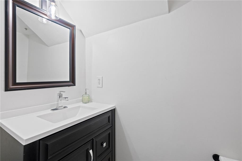 383 Ralph McGill Boulevard Northeast, Unit J Atlanta, GA 30312 - Photo 16 of 33 a bathroom with a sink vanity and a mirror
