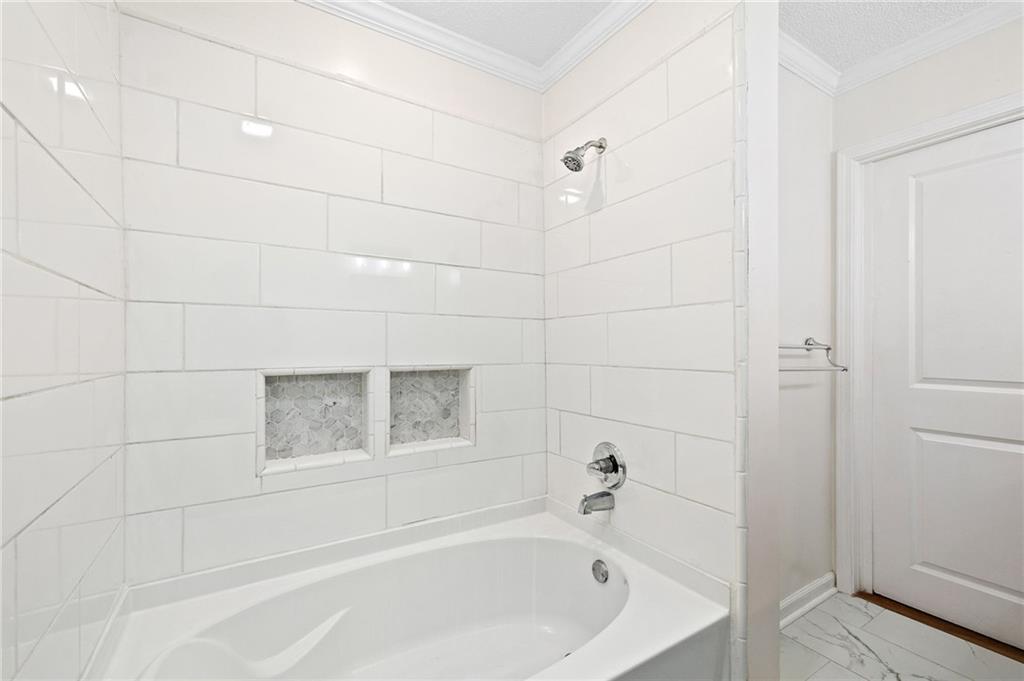 383 Ralph McGill Boulevard Northeast, Unit J Atlanta, GA 30312 - Photo 17 of 28 a bathroom with a bathtub