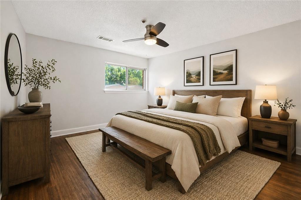 383 Ralph McGill Boulevard Northeast, Unit J Atlanta, GA 30312 - Photo 17 of 33 a bedroom with a bed and wooden floor