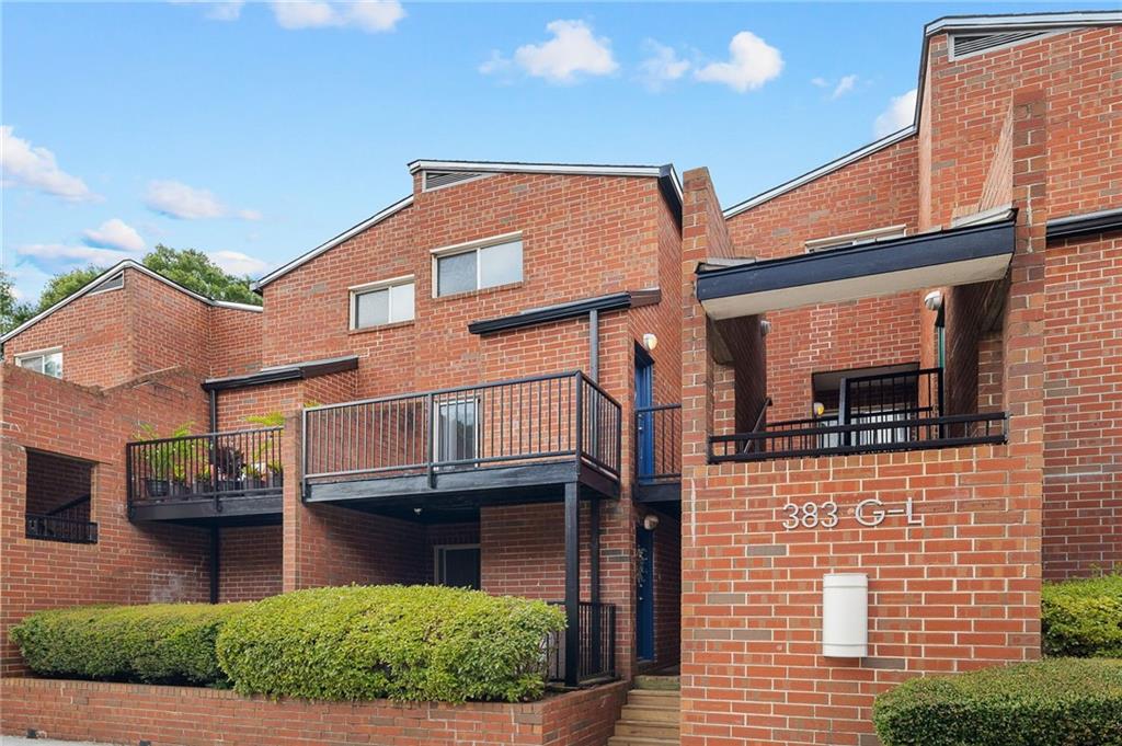 383 Ralph McGill Boulevard Northeast, Unit J Atlanta, GA 30312 - Photo 27 of 28 a front view of a house with garden